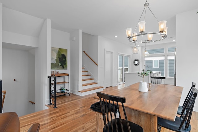 dining space featuring light wood-type flooring, stairs, baseboards, and recessed lighting