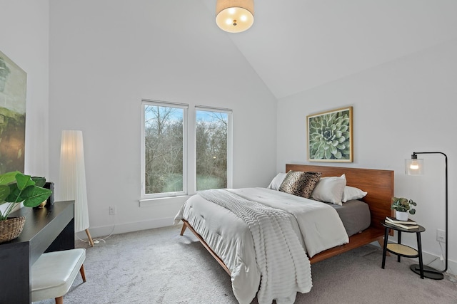 bedroom featuring carpet floors, baseboards, and high vaulted ceiling