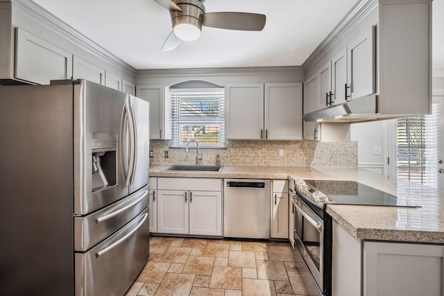 kitchen with tasteful backsplash, ceiling fan, light stone counters, stainless steel appliances, and a sink