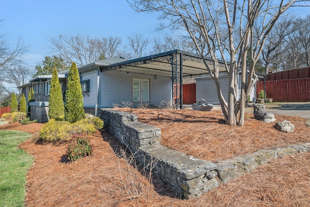 view of side of home with fence