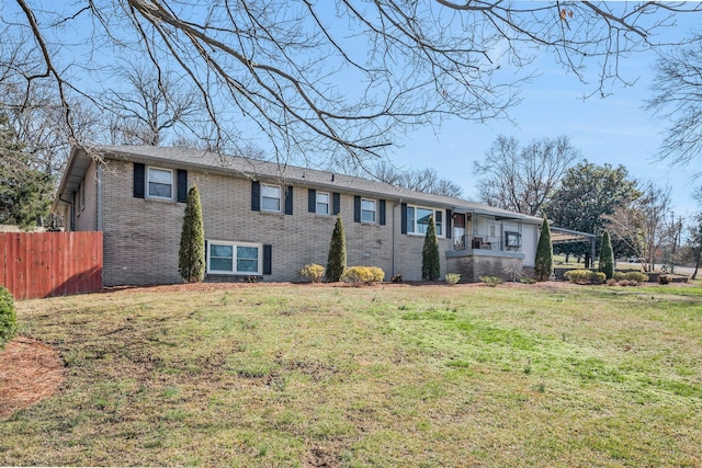 single story home featuring fence, a front lawn, and brick siding