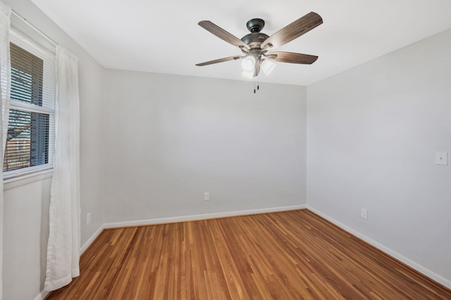 unfurnished room featuring ceiling fan, baseboards, and wood finished floors