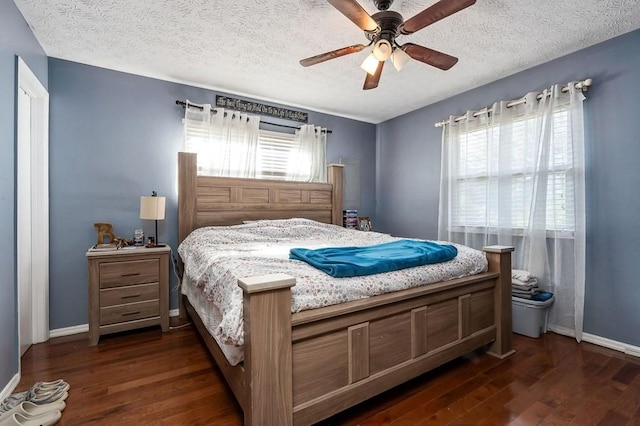 bedroom with dark wood finished floors, a textured ceiling, baseboards, and ceiling fan