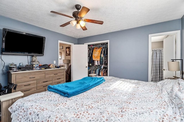 bedroom with a ceiling fan, a closet, and a textured ceiling