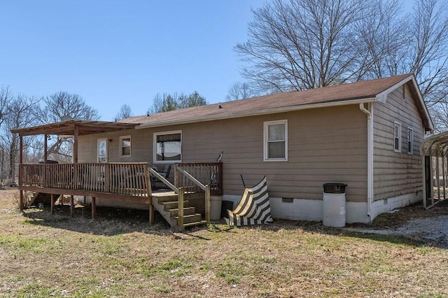 rear view of house featuring crawl space, a yard, and a wooden deck