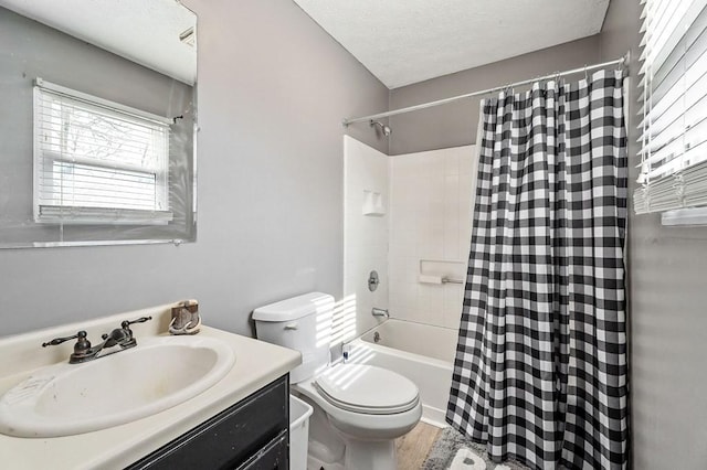 full bathroom featuring a textured ceiling, toilet, wood finished floors, vanity, and shower / tub combo with curtain