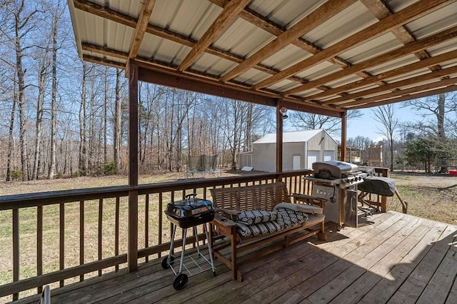 deck featuring a trampoline, grilling area, and an outdoor structure