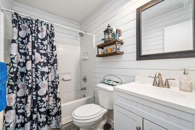 full bathroom featuring toilet, shower / bath combo, a textured ceiling, and vanity