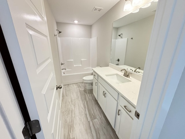 full bathroom featuring washtub / shower combination, visible vents, vanity, and toilet