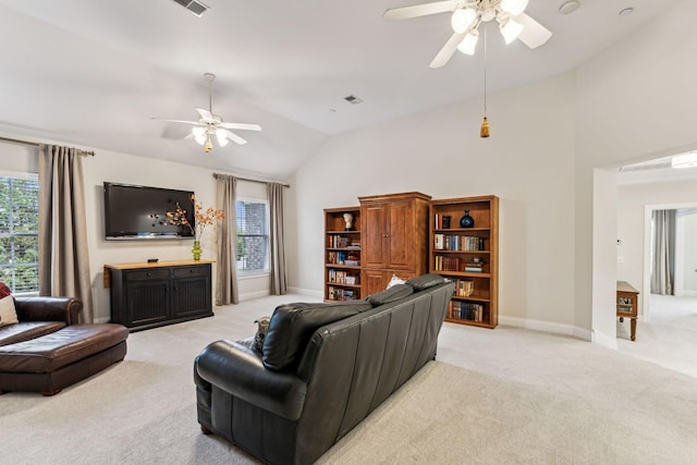 living room with light carpet, baseboards, a ceiling fan, and lofted ceiling