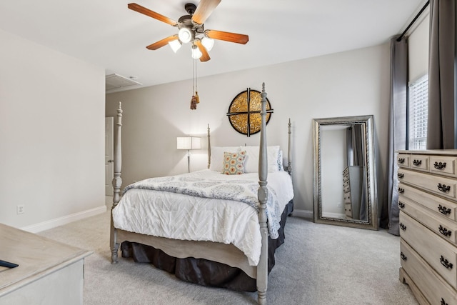 bedroom featuring attic access, light carpet, baseboards, and a ceiling fan