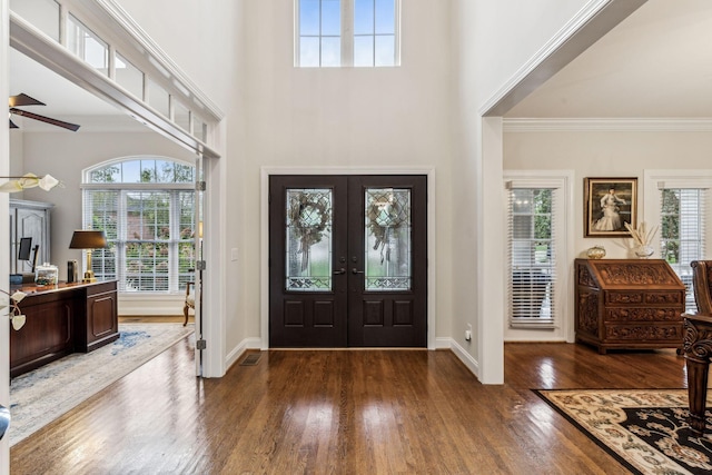 foyer featuring baseboards, ornamental molding, dark wood finished floors, and french doors