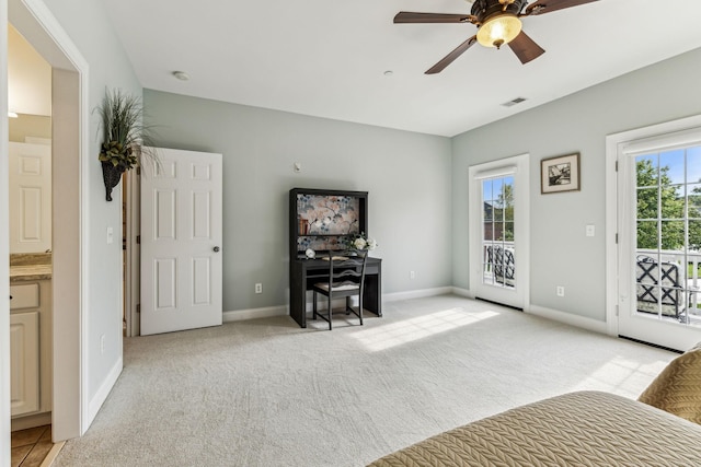 interior space featuring baseboards, a ceiling fan, visible vents, and light colored carpet