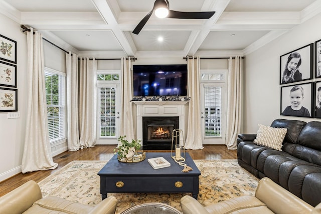 living room featuring dark wood-style floors, beamed ceiling, coffered ceiling, and a fireplace with flush hearth