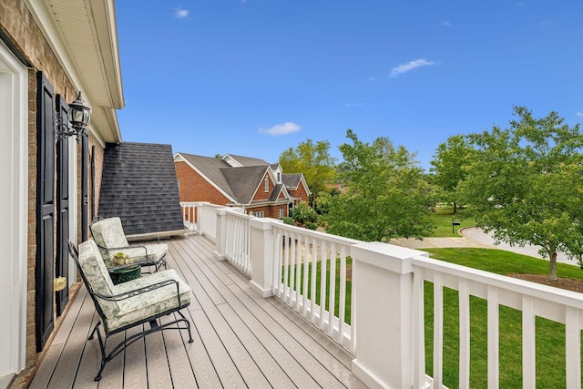 wooden deck featuring a yard