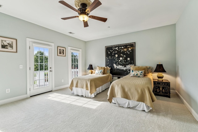 bedroom with light carpet, access to outside, visible vents, and baseboards