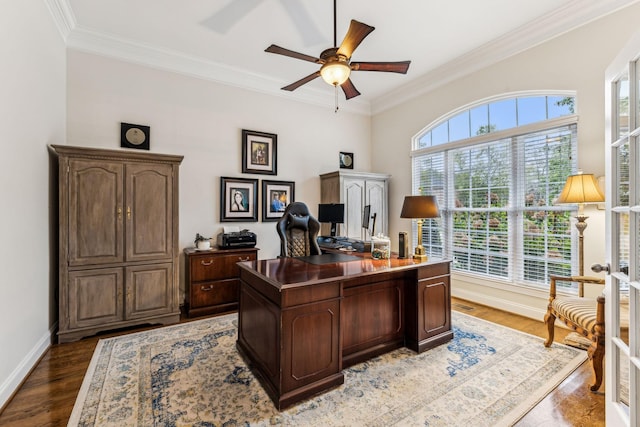 home office featuring baseboards, visible vents, a ceiling fan, ornamental molding, and wood finished floors