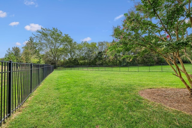 view of yard with a rural view and fence