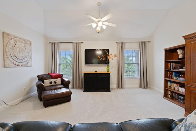 living room with lofted ceiling, light colored carpet, ceiling fan, and baseboards