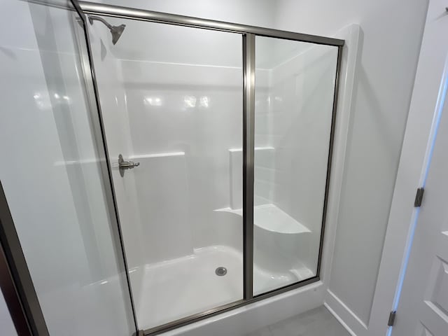 full bath with a shower stall