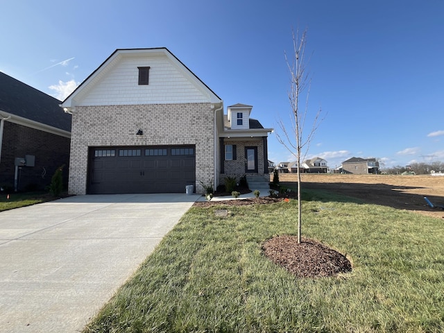 view of front of house with driveway, a garage, a front lawn, and brick siding