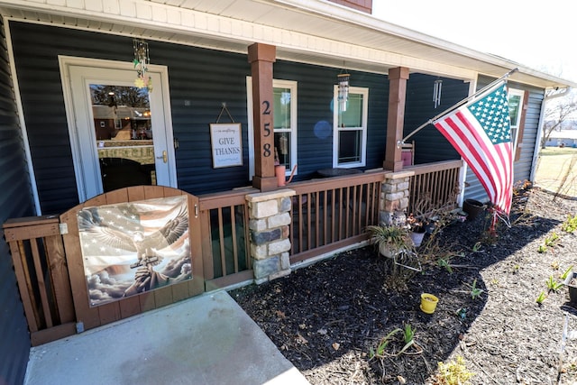 view of exterior entry with a porch