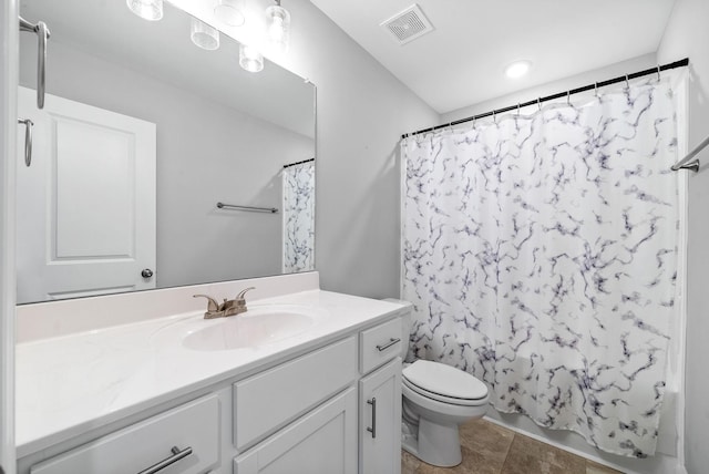 full bathroom with toilet, vanity, visible vents, tile patterned floors, and shower / bath combo