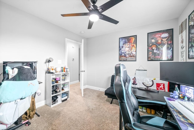 office area featuring a ceiling fan, baseboards, and carpet flooring