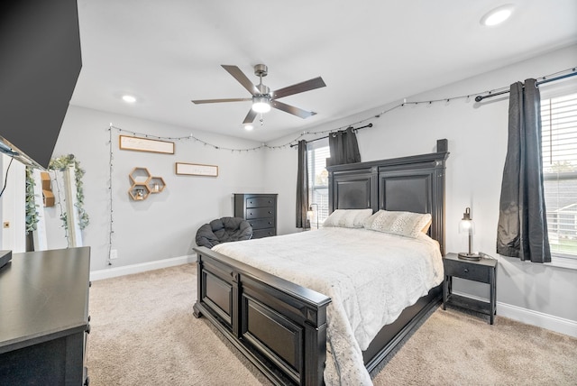 bedroom with a ceiling fan, recessed lighting, light carpet, and baseboards