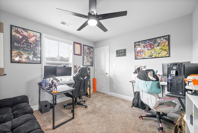 office space with light carpet, a ceiling fan, visible vents, and baseboards