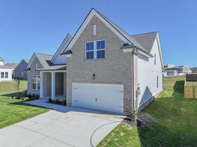 traditional home with concrete driveway, roof with shingles, an attached garage, a front lawn, and brick siding