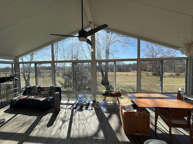 sunroom with vaulted ceiling with beams, plenty of natural light, and ceiling fan