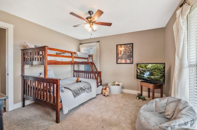 carpeted bedroom featuring baseboards