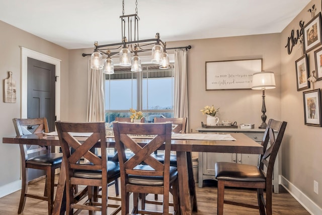 dining room featuring baseboards and wood finished floors