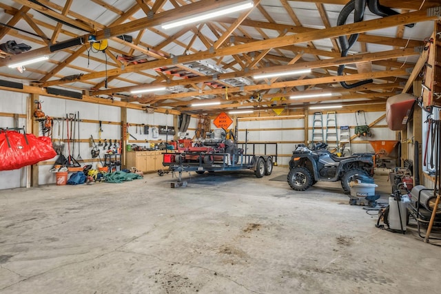 garage featuring a workshop area and metal wall