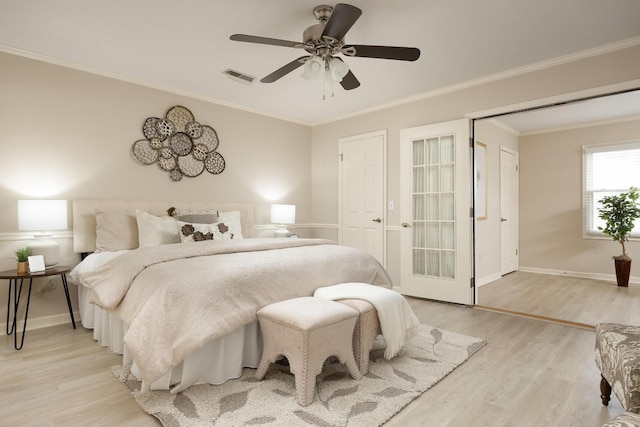 bedroom with crown molding, visible vents, light wood-style flooring, a ceiling fan, and baseboards