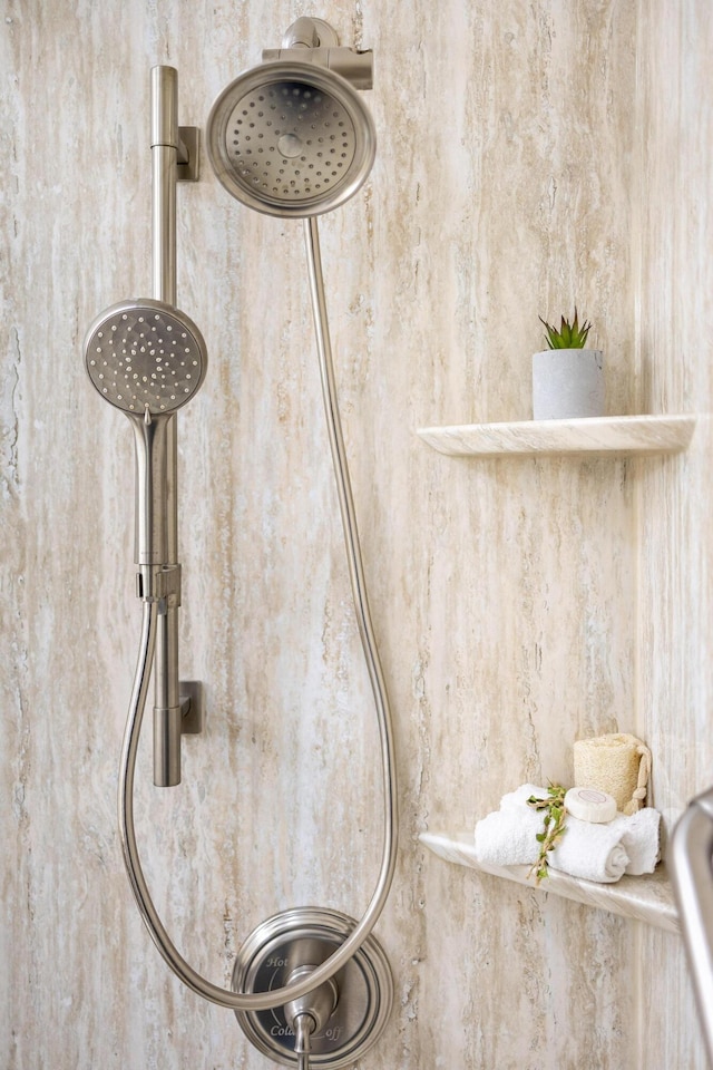 interior details with a tile shower