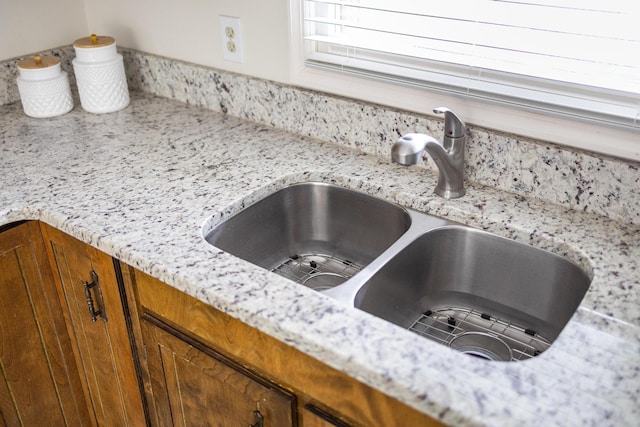 interior details with a sink and brown cabinets