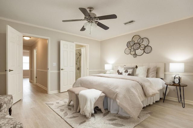 bedroom with visible vents, crown molding, light wood-style flooring, and baseboards