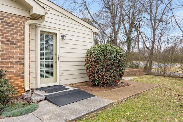 view of exterior entry with brick siding