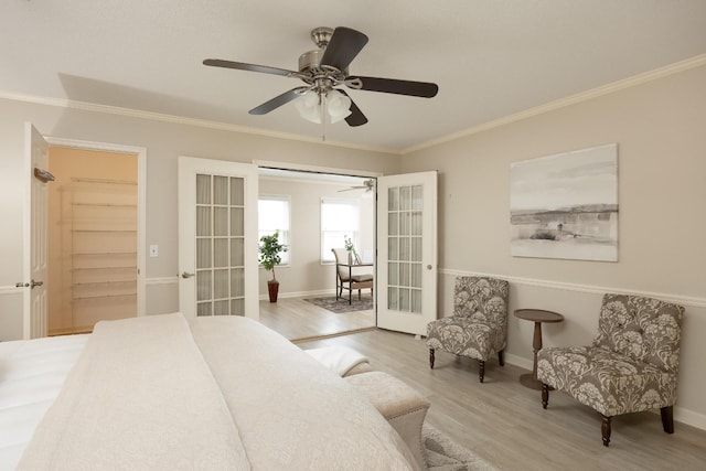 bedroom featuring baseboards, ceiling fan, wood finished floors, crown molding, and french doors