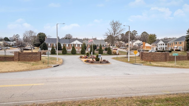 view of street featuring street lighting, traffic signs, and a residential view