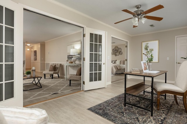 office area with visible vents, a ceiling fan, ornamental molding, wood finished floors, and french doors