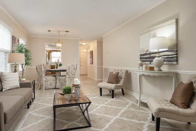 living room with wood finished floors and crown molding