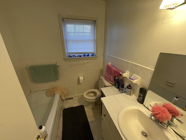 bathroom with a tub to relax in, visible vents, toilet, tile patterned flooring, and tile walls