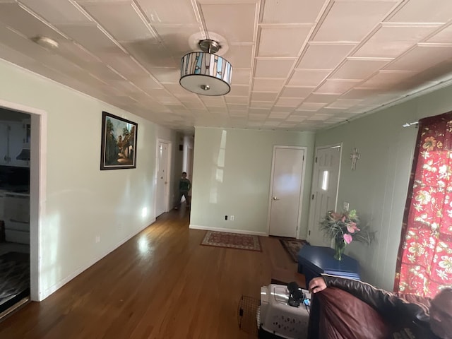 interior space with baseboards and dark wood-style flooring