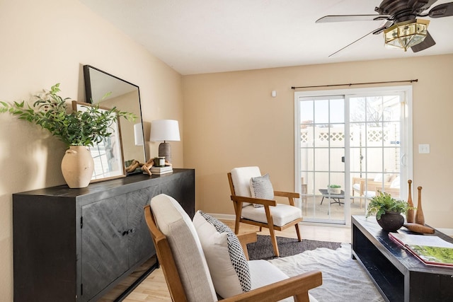 sitting room featuring light wood-style floors, ceiling fan, and baseboards