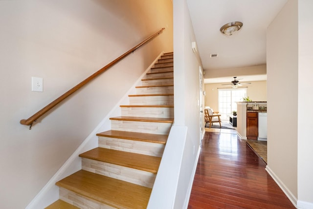 stairway with hardwood / wood-style flooring, ceiling fan, and baseboards