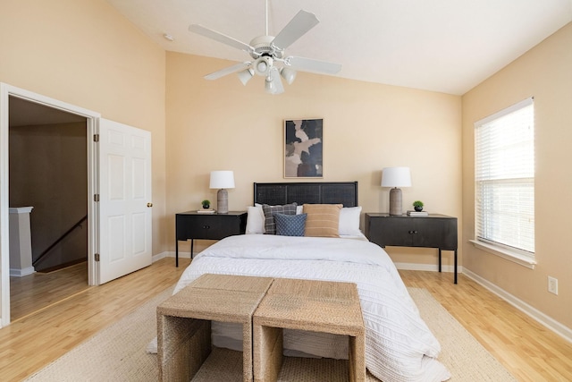 bedroom with lofted ceiling, ceiling fan, baseboards, and wood finished floors