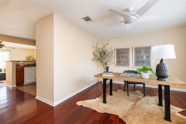 home office with visible vents, ceiling fan, baseboards, and wood finished floors